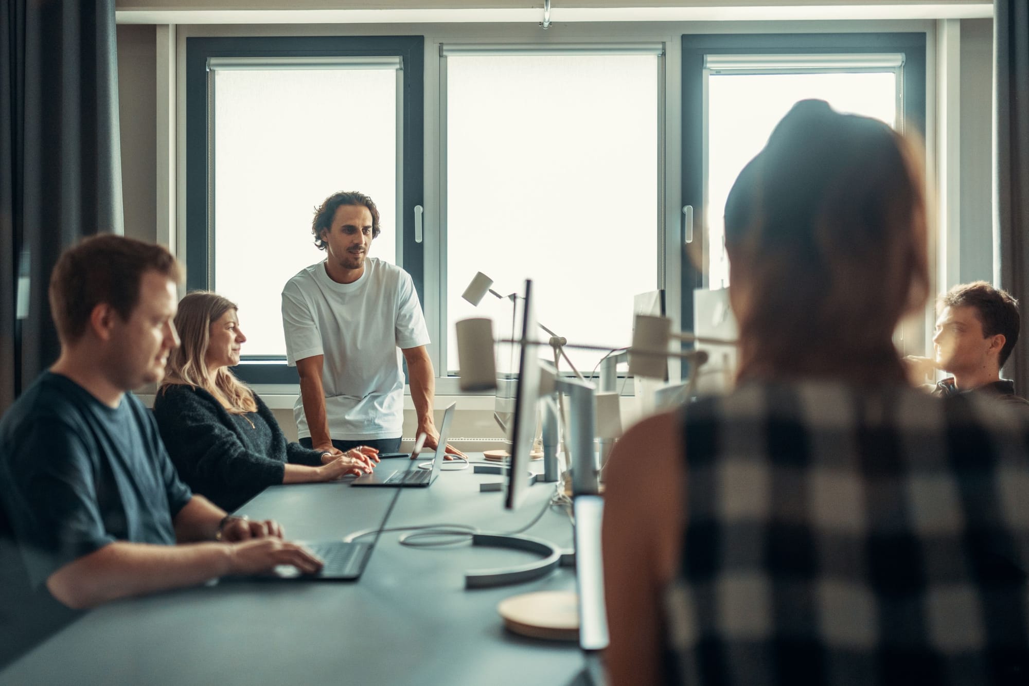 A team collaborating around a table in a workshop